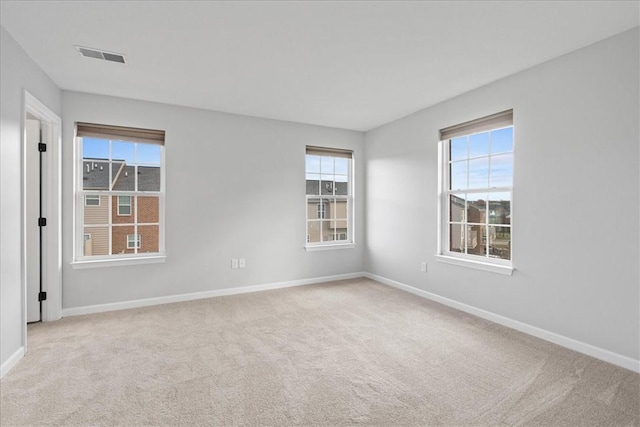 spare room featuring light colored carpet