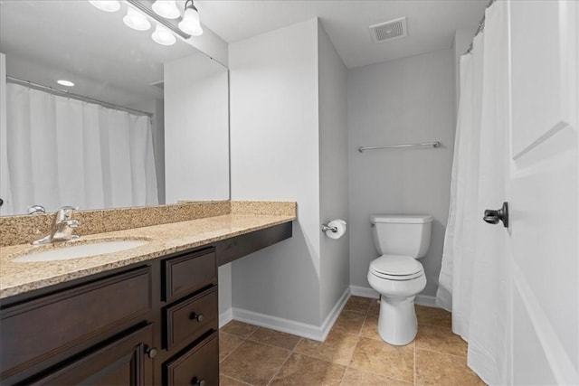 bathroom featuring tile patterned floors, vanity, and toilet