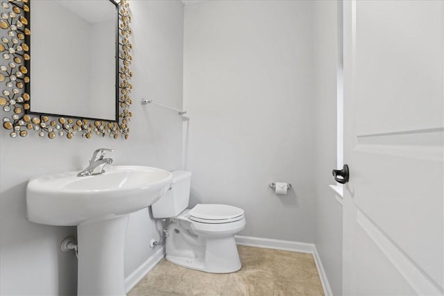 bathroom featuring tile patterned floors and toilet