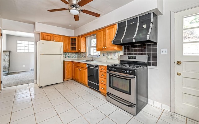 kitchen featuring black dishwasher, white refrigerator, a wealth of natural light, and stainless steel gas range