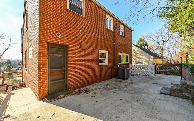 view of side of home featuring a patio and central air condition unit