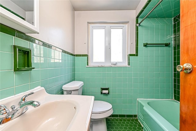 full bathroom with tile patterned flooring, toilet, tile walls, and sink