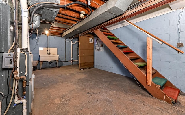 basement featuring heating unit and sink