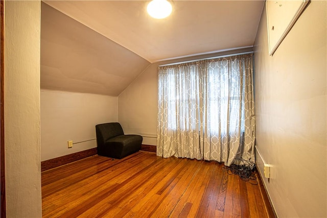 additional living space featuring hardwood / wood-style flooring and vaulted ceiling