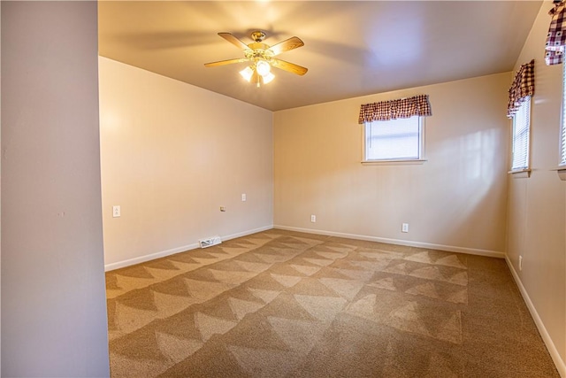 carpeted empty room featuring ceiling fan