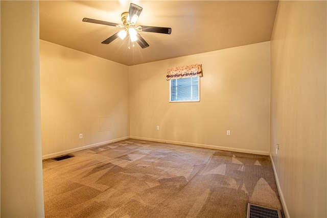 empty room featuring ceiling fan and carpet