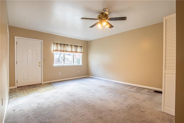 empty room featuring light carpet and ceiling fan