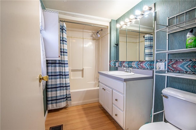 full bathroom with hardwood / wood-style floors, vanity, toilet, and shower / bathtub combination with curtain