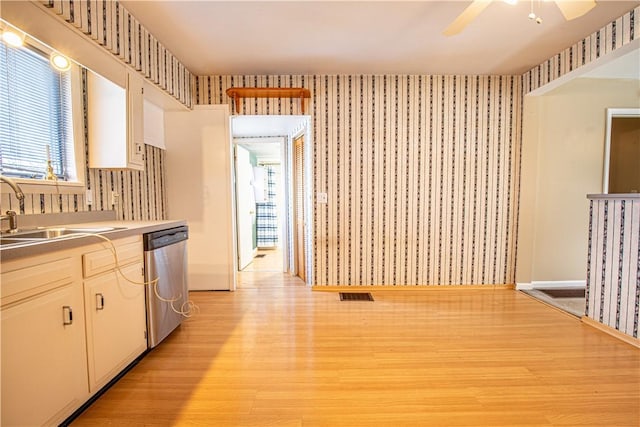 kitchen featuring white cabinets, ceiling fan, sink, light hardwood / wood-style flooring, and dishwasher