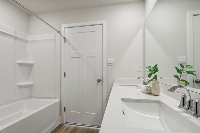 bathroom featuring shower / bath combination, vanity, and wood-type flooring