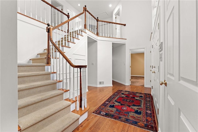 entryway featuring a high ceiling and hardwood / wood-style flooring