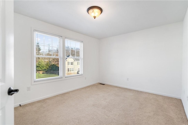 spare room with light colored carpet