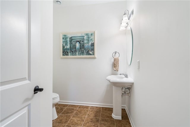 bathroom with tile patterned flooring and toilet