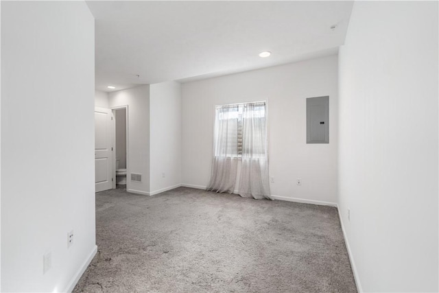 spare room with electric panel and carpet