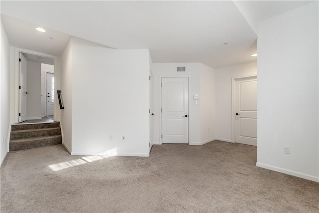 unfurnished room with light colored carpet