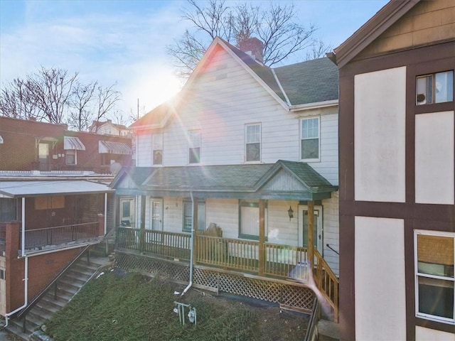 back of property with covered porch