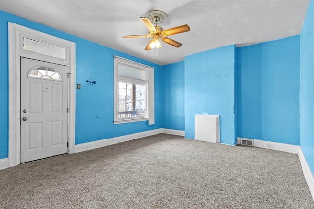 carpeted entryway featuring ceiling fan and radiator