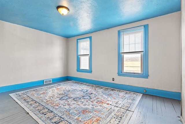 unfurnished room featuring hardwood / wood-style floors