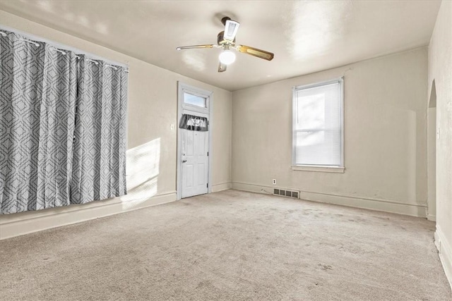 carpeted empty room with ceiling fan