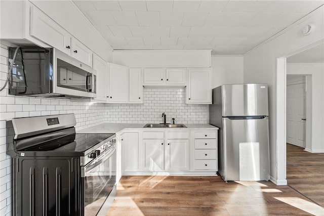 kitchen featuring white cabinetry, sink, dark hardwood / wood-style floors, and appliances with stainless steel finishes