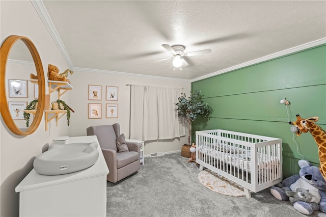 bedroom featuring crown molding, a nursery area, light carpet, and ceiling fan