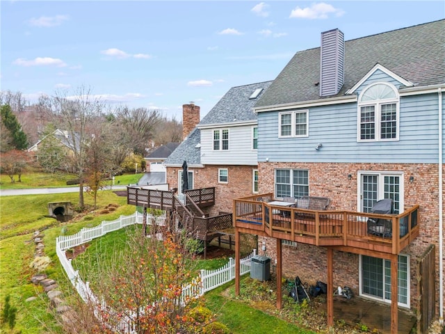 back of house with central AC and a deck