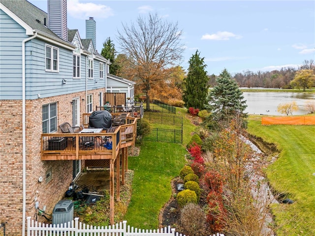 view of yard featuring central AC and a deck with water view