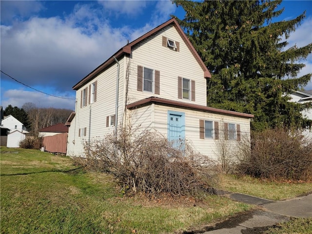 view of side of home with a yard