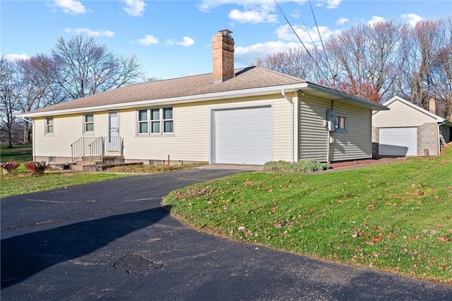 view of front facade with a front yard and a garage