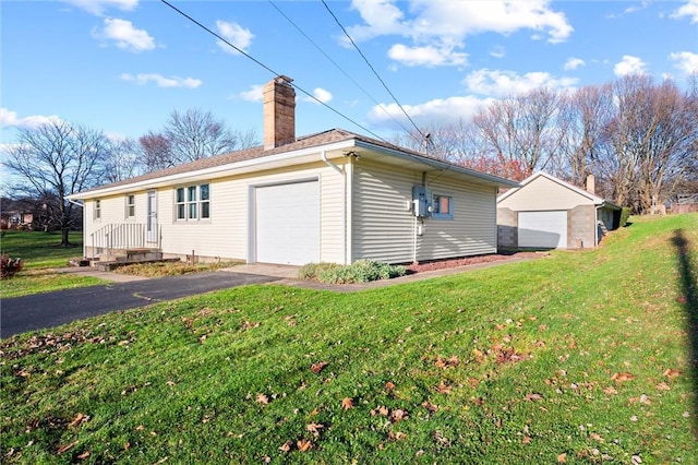 view of property exterior with an outbuilding, a garage, and a lawn