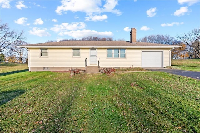 view of front of property with a garage and a front lawn