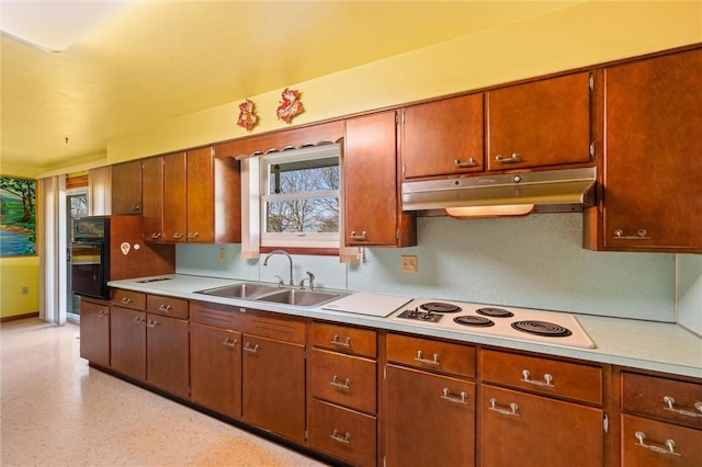 kitchen featuring oven, white electric stovetop, and sink