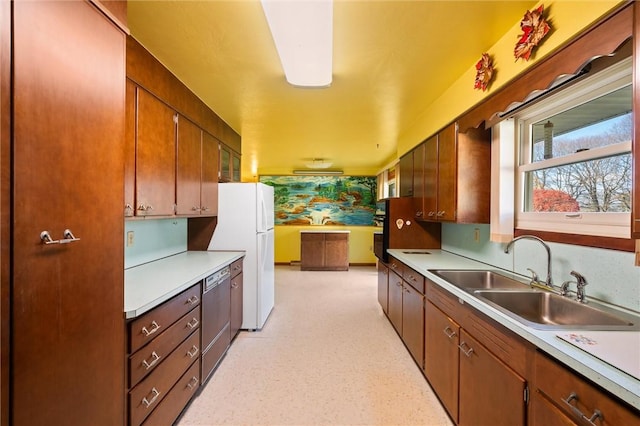 kitchen with white fridge, stainless steel dishwasher, and sink