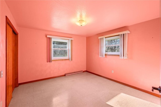 unfurnished bedroom featuring a baseboard heating unit