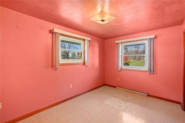 unfurnished room featuring baseboard heating