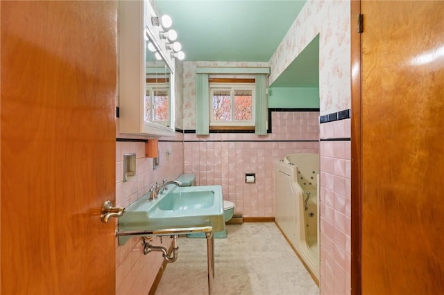 bathroom featuring sink, a bath, tile walls, and tile patterned flooring