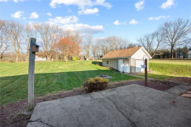 view of patio featuring an outbuilding and a garage