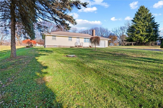 exterior space featuring a lawn and a garage