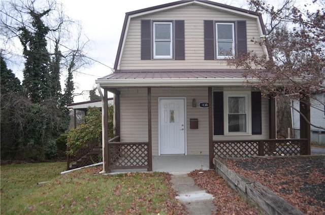 view of front of home with covered porch and a front yard