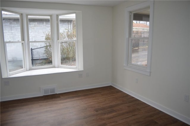 spare room with dark hardwood / wood-style floors