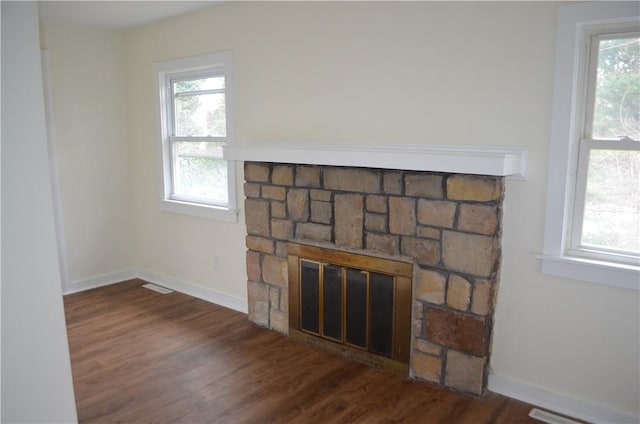 interior details featuring a fireplace and wood-type flooring