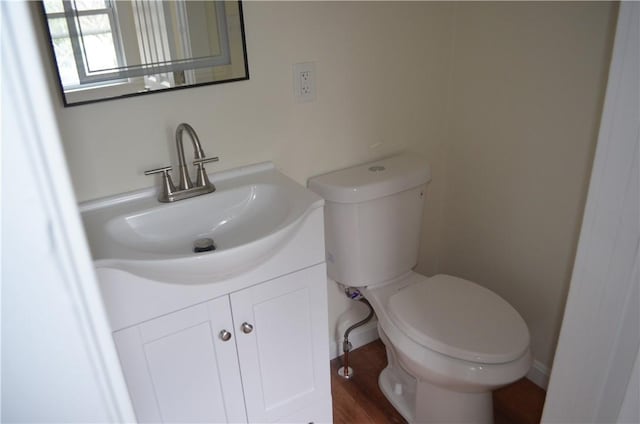 bathroom featuring vanity, toilet, and wood-type flooring