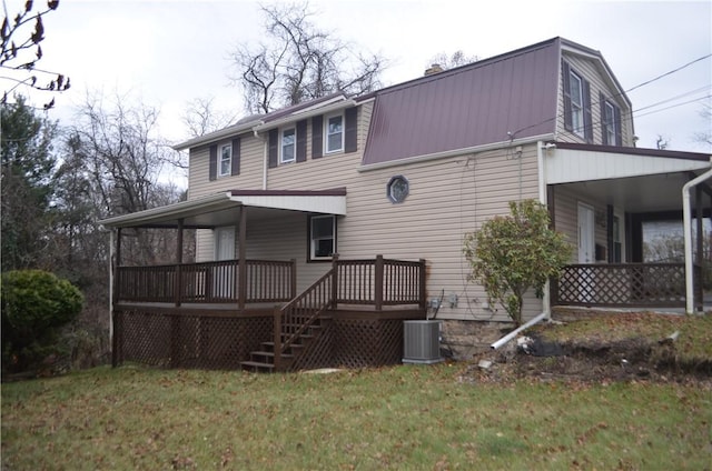 back of house with a lawn, cooling unit, and covered porch