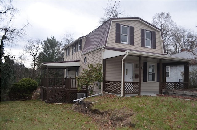 view of front facade featuring central AC unit, covered porch, and a front yard