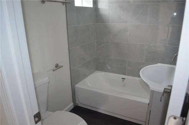 full bathroom featuring vanity, toilet, and tiled shower / bath