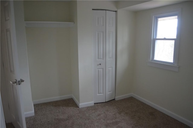 unfurnished bedroom with carpet floors and a closet