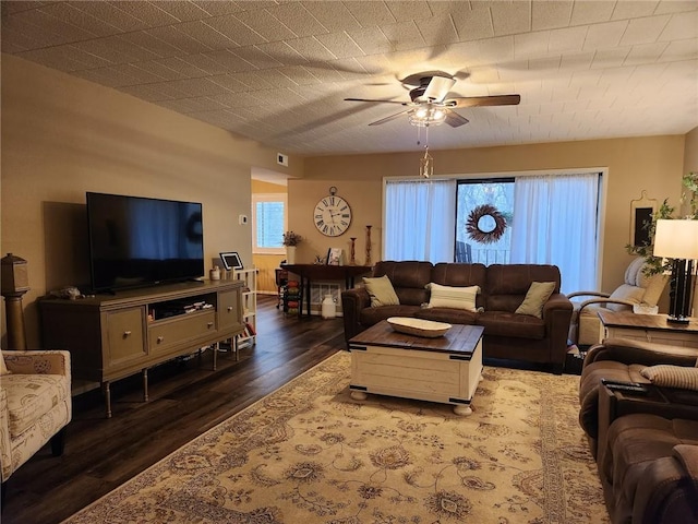 living room with ceiling fan and dark hardwood / wood-style floors