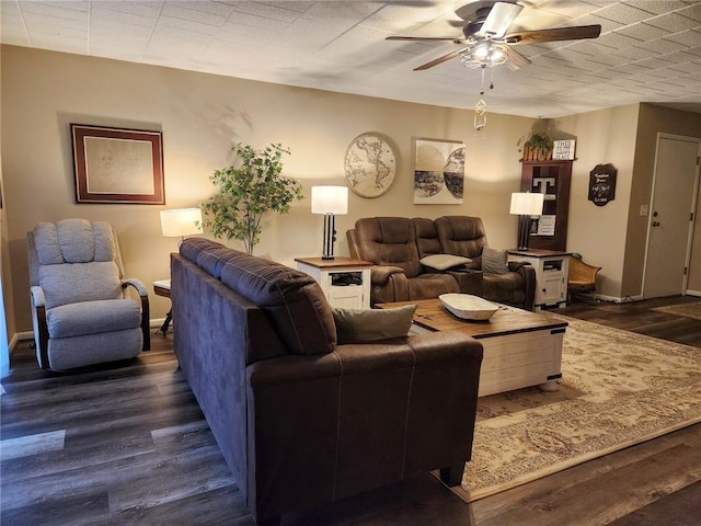 living room with ceiling fan and dark hardwood / wood-style flooring