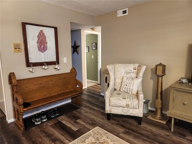 sitting room with dark wood-type flooring