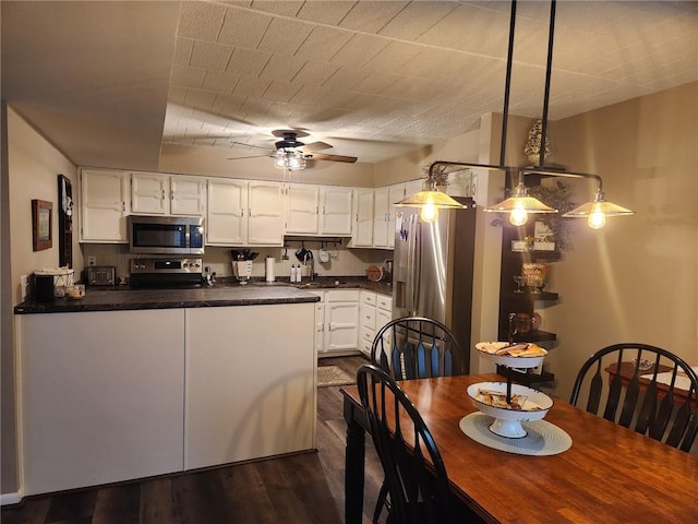 dining space with dark hardwood / wood-style floors, ceiling fan, and sink